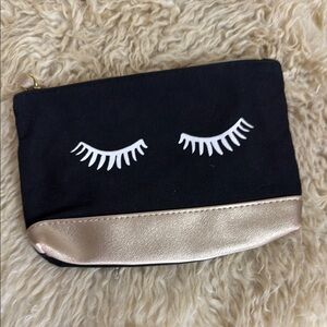IPSY Black Pouch with Gold Zipper. Girlie design with eyelashes and rose gold.
